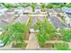 Aerial view of a single-Gathering home with mature trees and a driveway in a residential neighborhood at 15410 Quail Woods Pl, Ruskin, FL 33573
