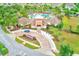 Aerial view of community clubhouse with a charming entrance and manicured landscaping and sign at 15410 Quail Woods Pl, Ruskin, FL 33573