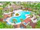 Aerial view of a resort-style pool area with palm trees, pergolas, and seating at 15410 Quail Woods Pl, Ruskin, FL 33573
