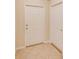 Bright entryway with tile floors showcasing the front door and a hallway door at 15410 Quail Woods Pl, Ruskin, FL 33573