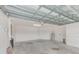 Spacious garage with high ceilings, concrete floor, and utilities for storage and functionality at 15410 Quail Woods Pl, Ruskin, FL 33573