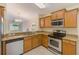Updated kitchen with stainless steel appliances and a view into the living area at 15410 Quail Woods Pl, Ruskin, FL 33573