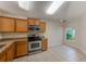 Spacious kitchen with stainless steel appliances and tile flooring leads to a breakfast nook at 15410 Quail Woods Pl, Ruskin, FL 33573