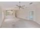 Spacious living area providing a view of the kitchen featuring a breakfast bar and ceiling fan at 15410 Quail Woods Pl, Ruskin, FL 33573