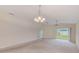 Large living room featuring plush carpet, ceiling fan and sliding glass doors to the backyard at 15410 Quail Woods Pl, Ruskin, FL 33573