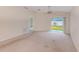 Bright living room with sliding glass doors that let in plenty of natural light and a ceiling fan at 15410 Quail Woods Pl, Ruskin, FL 33573