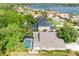 Aerial view of a lakeside community, showcasing homes with pools and lush landscaping at 16522 Ivy Lake Dr, Odessa, FL 33556