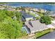 Areal home view with screened pool in lush community by lake, highlighting location at 16522 Ivy Lake Dr, Odessa, FL 33556