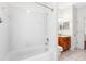 Bathroom featuring a white tiled shower/tub combo and a vanity with wood cabinets at 16522 Ivy Lake Dr, Odessa, FL 33556
