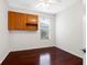 Bright bedroom features hardwood floors, storage cabinets, and a sunlit window at 16522 Ivy Lake Dr, Odessa, FL 33556