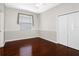 Bedroom featuring hardwood floors, double door closet, and ample natural lighting at 16522 Ivy Lake Dr, Odessa, FL 33556