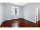 Bedroom featuring hardwood floors, a window with curtains, and neutral wall paint at 16522 Ivy Lake Dr, Odessa, FL 33556