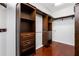 Walk-in closet with custom built-in shelves, drawers, and ample hanging space at 16522 Ivy Lake Dr, Odessa, FL 33556
