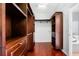 Custom walk-in closet featuring wood shelves, drawers, and easy access to the bathroom at 16522 Ivy Lake Dr, Odessa, FL 33556