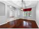 Dining room with hardwood floors, elegant lighting, and views of the front yard at 16522 Ivy Lake Dr, Odessa, FL 33556