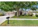Traditional home featuring a lush front yard, mature shade tree, and multi car garage at 16522 Ivy Lake Dr, Odessa, FL 33556
