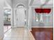 Bright foyer with large windows, tile floors, and view into the living spaces beyond at 16522 Ivy Lake Dr, Odessa, FL 33556
