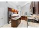 Well-equipped kitchen with a center island, stainless appliances, granite counters, and ample cabinet space at 16522 Ivy Lake Dr, Odessa, FL 33556
