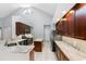 Bright kitchen boasts granite countertops, stainless steel appliances, island, and tiled floor at 16522 Ivy Lake Dr, Odessa, FL 33556