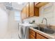 Laundry room featuring a washing machine, sink, cabinets, and wire rack shelving at 16522 Ivy Lake Dr, Odessa, FL 33556