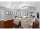 Staged living room with hardwood floors, vaulted ceilings, and a seamless flow to outdoor pool area at 16522 Ivy Lake Dr, Odessa, FL 33556