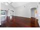 Expansive living room with hardwood floors, vaulted ceilings, and access to outdoor space at 16522 Ivy Lake Dr, Odessa, FL 33556