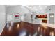 Open-concept living space with hardwood floors, high ceilings, and seamless transition to the kitchen at 16522 Ivy Lake Dr, Odessa, FL 33556