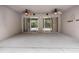 Expansive covered patio featuring dual ceiling fans and access to the screened-in pool area at 16522 Ivy Lake Dr, Odessa, FL 33556