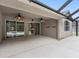 Spacious covered patio with ceiling fans and sliding glass doors leading to the pool area at 16522 Ivy Lake Dr, Odessa, FL 33556