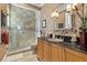 A traditionally designed bathroom with glass enclosed shower, and black granite countertop at 1737 Brightwaters Ne Blvd, St Petersburg, FL 33704