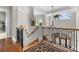 Upstairs foyer features wood floors with an oriental rug, and wrought iron staircase at 1737 Brightwaters Ne Blvd, St Petersburg, FL 33704
