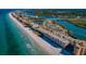 Aerial of beach front property, ocean view, and nearby waterway at 18650 Gulf Blvd # 601, Indian Shores, FL 33785