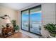 View to the balcony from the living room features seating and stunning ocean vista at 18650 Gulf Blvd # 601, Indian Shores, FL 33785