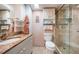 Well lit bathroom featuring a granite countertop vanity, toilet and glass enclosed shower at 18650 Gulf Blvd # 601, Indian Shores, FL 33785