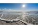 Scenic beach with clear water and gentle waves under a sunny sky at 18650 Gulf Blvd # 601, Indian Shores, FL 33785