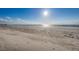 Expansive sandy beach with gentle waves under a bright, sunny sky at 18650 Gulf Blvd # 601, Indian Shores, FL 33785