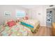 Bedroom with two twin beds, wood floors and white shuttered windows at 18650 Gulf Blvd # 601, Indian Shores, FL 33785