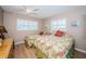 Bedroom featuring two beds, white shuttered windows, and a ceiling fan at 18650 Gulf Blvd # 601, Indian Shores, FL 33785