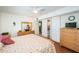 Bright bedroom with a ceiling fan, closet and dresser with an ensuite bathroom at 18650 Gulf Blvd # 601, Indian Shores, FL 33785