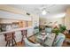 Dining area with glass table, bar seating, and seamless flow into the living room at 18650 Gulf Blvd # 601, Indian Shores, FL 33785