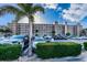 Exterior view of the building showing parking and professional landscaping at 18650 Gulf Blvd # 601, Indian Shores, FL 33785