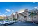 An exterior view of the condo complex with palm trees and well-maintained parking areas at 18650 Gulf Blvd # 601, Indian Shores, FL 33785