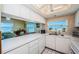 Bright, modern kitchen with white appliances and a pass-through to the dining area, offering ocean views at 18650 Gulf Blvd # 601, Indian Shores, FL 33785