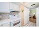 Well-maintained kitchen with white appliances and tiled backsplash, conveniently located near storage at 18650 Gulf Blvd # 601, Indian Shores, FL 33785
