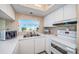Clean kitchen with white cabinets and modern appliances, featuring a bright window and beach view at 18650 Gulf Blvd # 601, Indian Shores, FL 33785