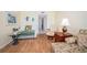 Inviting living room features wood floors, comfortable seating, and beach-themed decor at 18650 Gulf Blvd # 601, Indian Shores, FL 33785