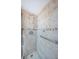 The tiled shower features a handheld shower head and a grab bar for safety at 18650 Gulf Blvd # 601, Indian Shores, FL 33785