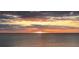 Striking sunset over the ocean with orange sky and clouds at 18650 Gulf Blvd # 601, Indian Shores, FL 33785