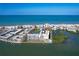 Beautiful aerial view featuring a condo community, a pool, tennis court, and waterfront access at 19451 Gulf Blvd # 211, Indian Shores, FL 33785