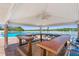 Covered bar area with counter seating overlooking the community pool and waterfront at 19451 Gulf Blvd # 211, Indian Shores, FL 33785